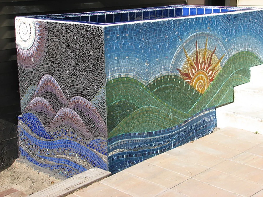 Twilight: a glass tile mosaic planter wrapping a starry night, purple hills and blue water around to a sunrise over green hills